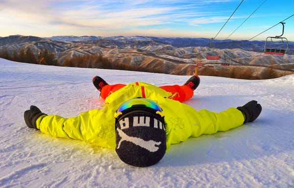 man laying in snow